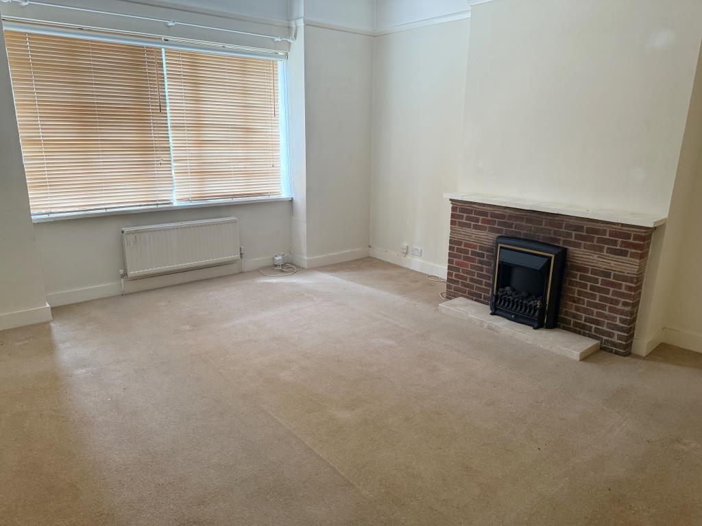 Lot: 19 - FREEHOLD GROUND RENTS WITH VACANT FLAT AND GARAGE - Living room with fireplace and window